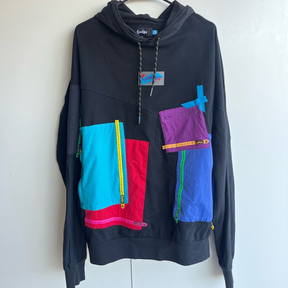 Cookies brand sweater. Size extra large, colorful, patchwork sweater small tear.